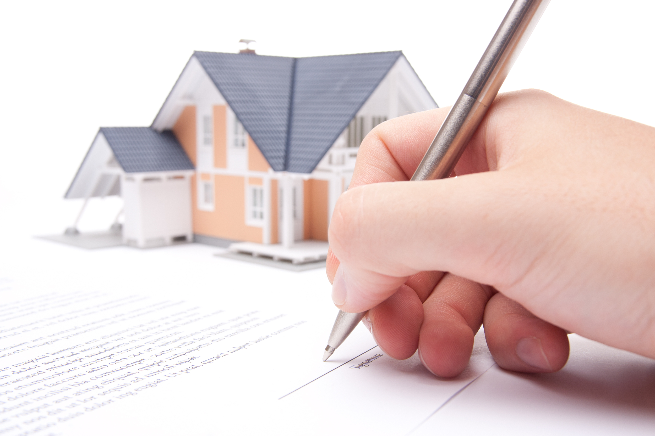 A woman signing real estate documents